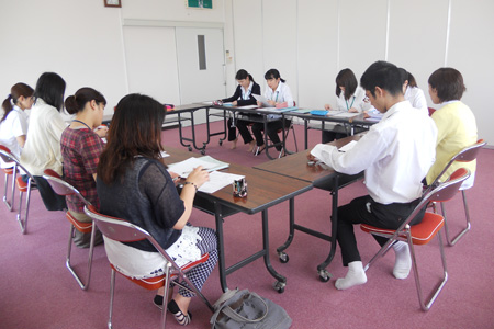 報告するの学生と指導者の真剣な様子
